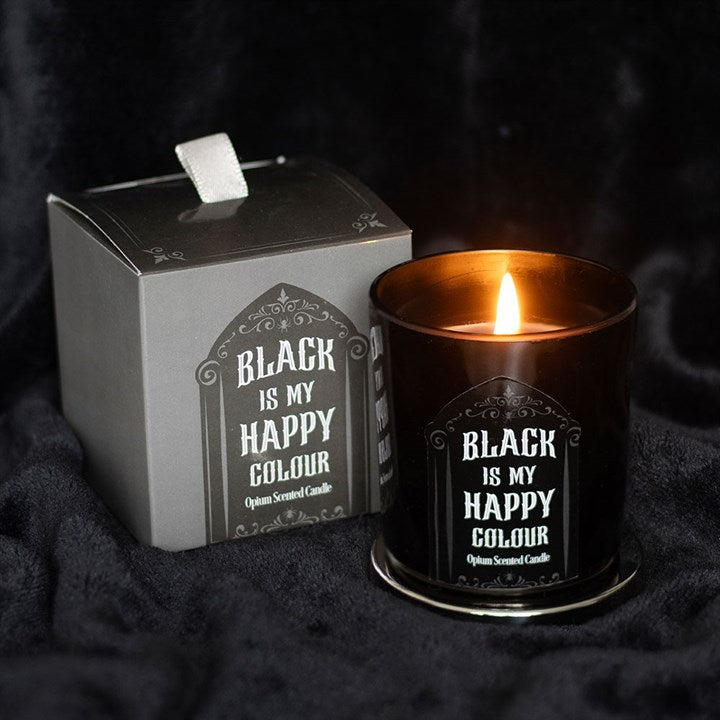 Candle in a black container with a label and matching box on a dark background